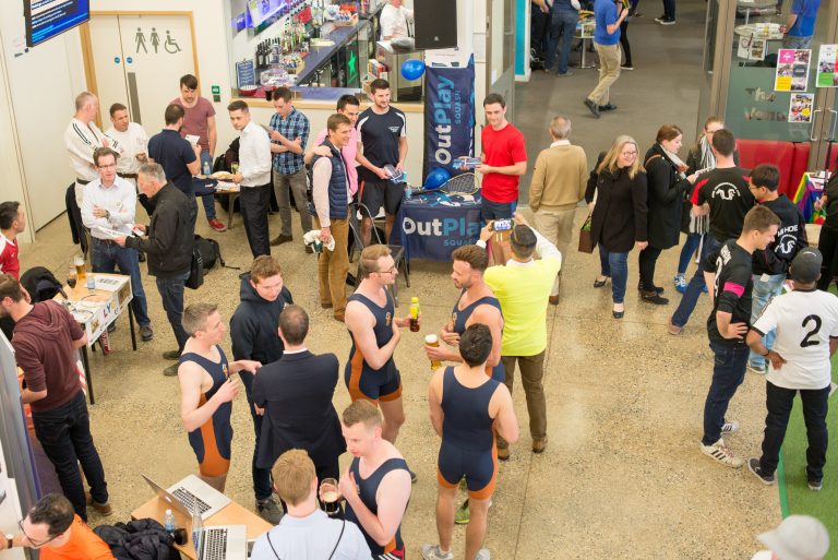 Groups of people talking to each other at the LGBTQ+ Sports Fair